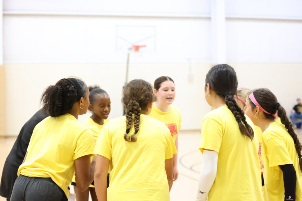 Female volleyball players discussing game play