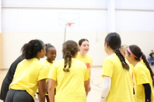 Female volleyball players discussing game play